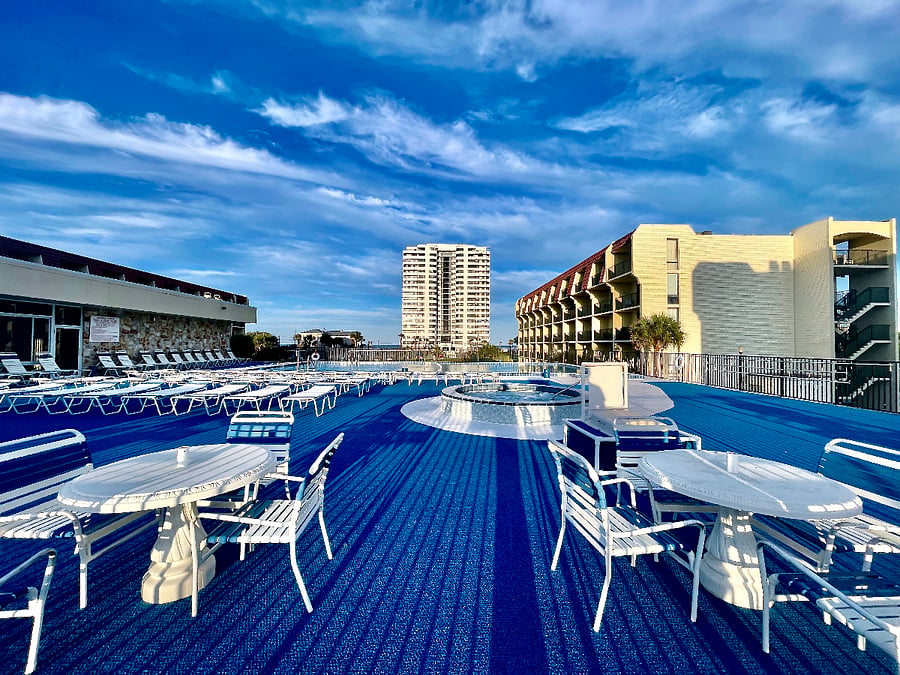 Well-maintained pool area with plenty of seating