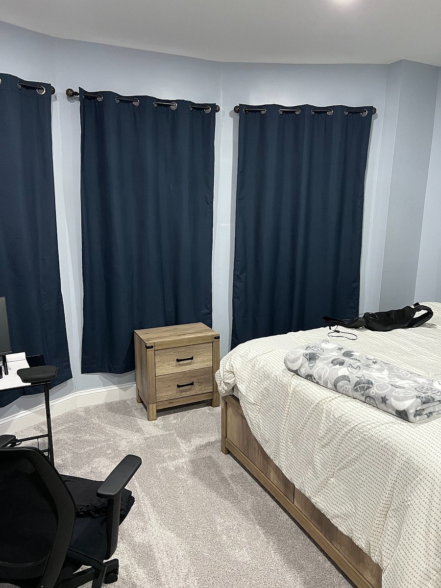 Additional bedroom featuring a dedicated workstation, blackout curtains, and a flat-screen TV with access to multiple streaming appsideal for remote work, relaxation, or extended stays