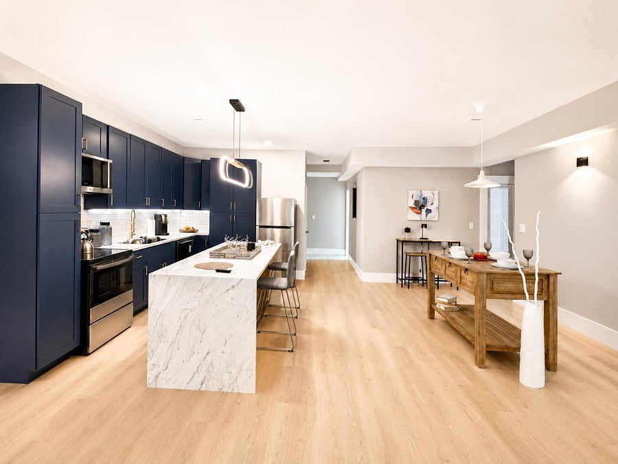 Full-size fridge, gas range, counter space for actual meal prep and a waterfall marble island with seating for three cook a real meal or just grab your coffee before heading out the door. 