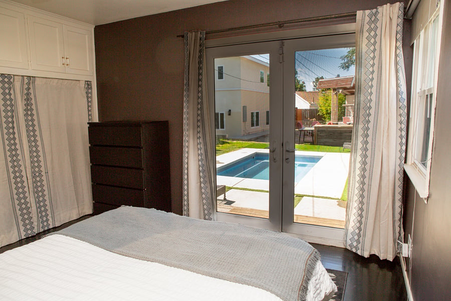queen bed pool view with french doors