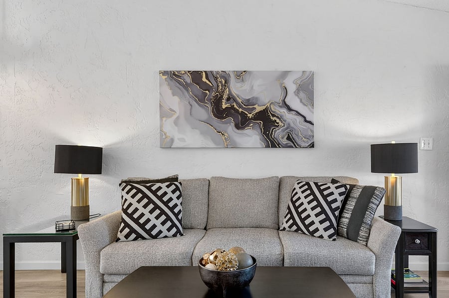 Cozy living room with a comfortable couch and large TVperfect for relaxing after a long day. Enjoy beautiful views of the patio and courtyard overlooking the golf course fairway. Includes a power-lift recliner for added comfort and ease.