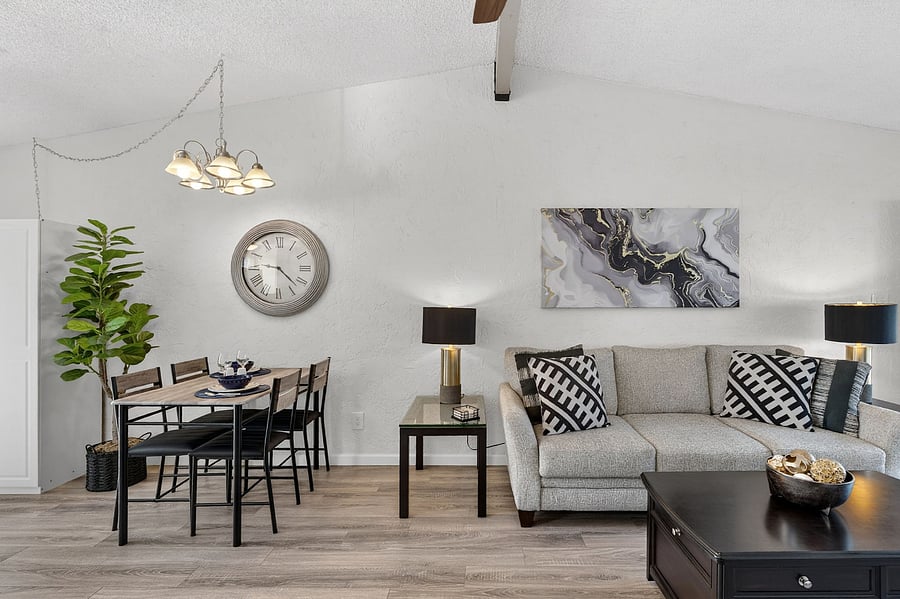 Cozy living room with a comfortable couch and large TVperfect for relaxing after a long day. Enjoy beautiful views of the patio and courtyard overlooking the golf course fairway. Includes a power-lift recliner for added comfort and ease.