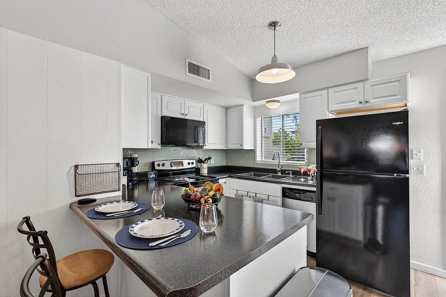 Fully equipped kitchen with breakfast bar and dining area just steps away for easy gatherings. Includes all the essentialsplus a blender for celebratory mixed drinks after a fun day on the golf course.