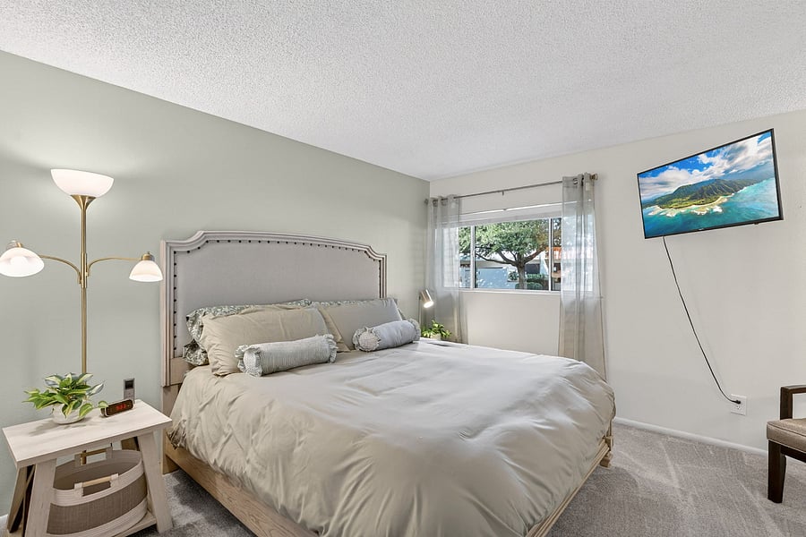 Primary bedroom features a Sleep Number king bed, a private en-suite bathroom, and a TV, your perfect retreat for rest, relaxation, and a little entertainment.