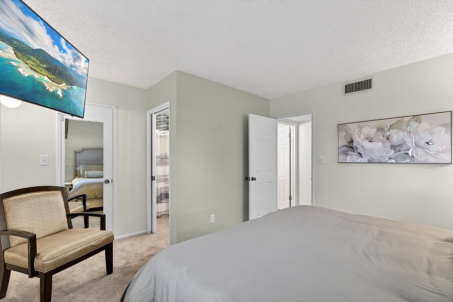 Primary bedroom features a Sleep Number king bed, a private en-suite bathroom, and a TVyour perfect retreat for rest, relaxation, and a little entertainment.