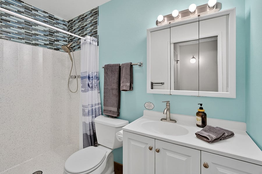 Full bathroom with a convenient step-in shower-- simple, comfortable, and ready for your daily routine.