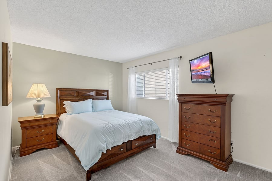 The second bedroom offers a queen bed and Smart TV, plus a twin fold-up roll-away in the closet, flexible sleeping options for family or guests.