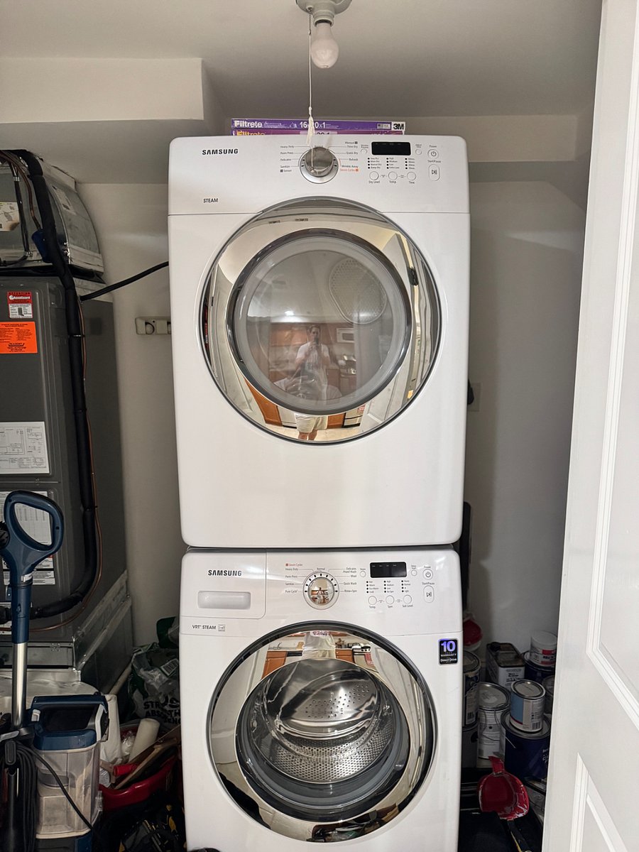 New front load washer and dryer in utility closet off kitchen