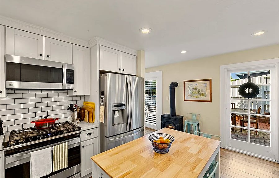 Kitchen with island seating and gas burning fire
