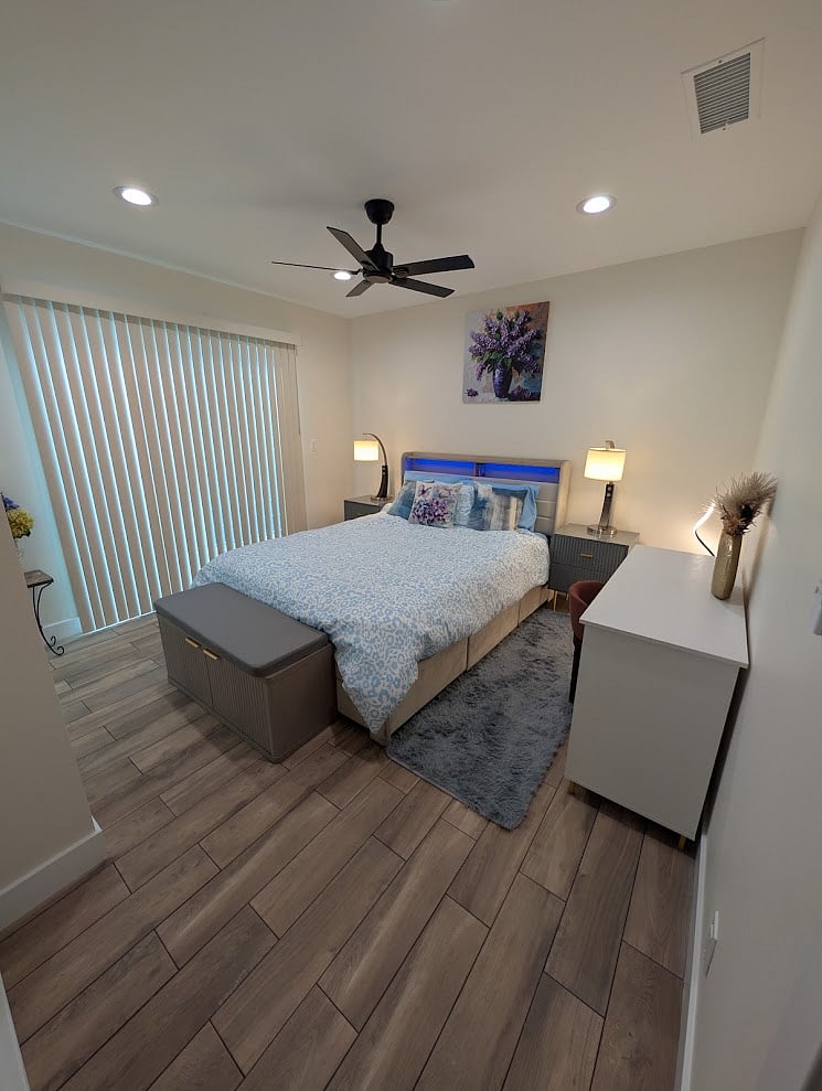 Cozy queen bedroom with fresh linens and natural light