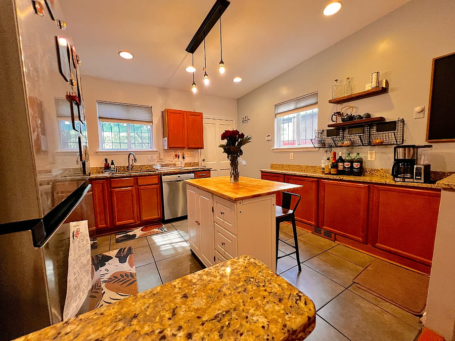 Kitchen w/ equipped with appliances and essential cookware