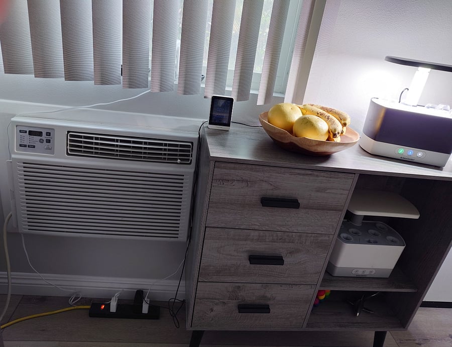 Window unit heats and cools downstairs.