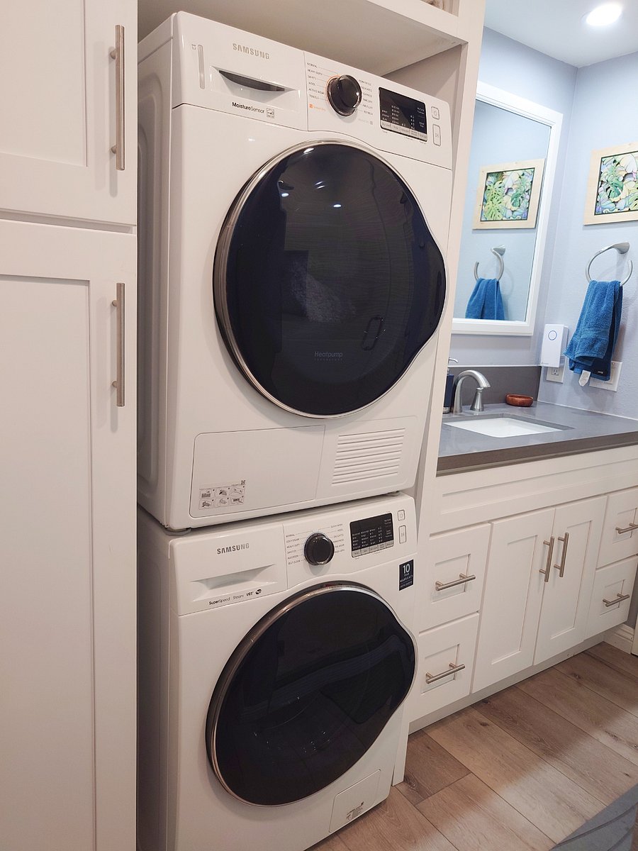 Stacked washer and dryer in upstairs bathroom.