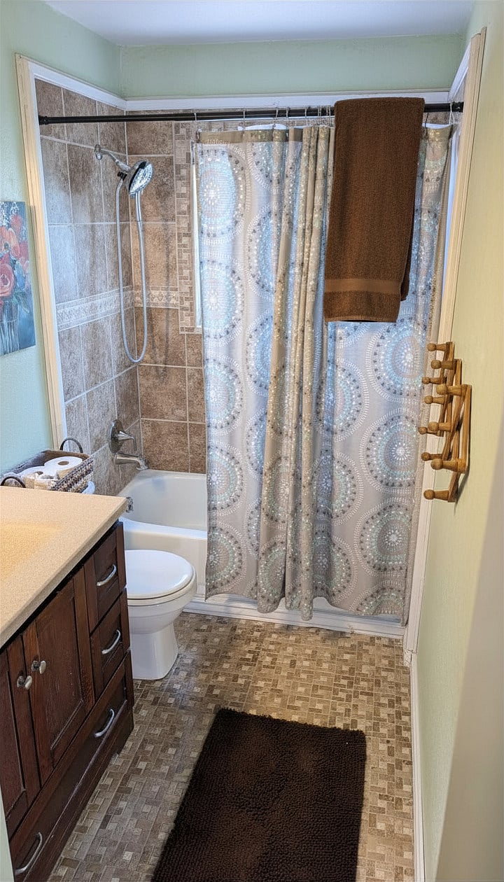 Upstairs bathroom with rain shower head, vanity with medicine cabinet, and heated floors.