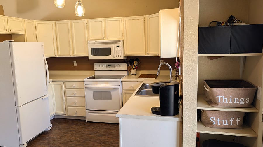 Additional storage and trash just outside the kitchen.