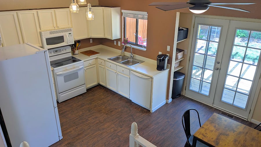 From stairs looking into kitchen and dining area. 