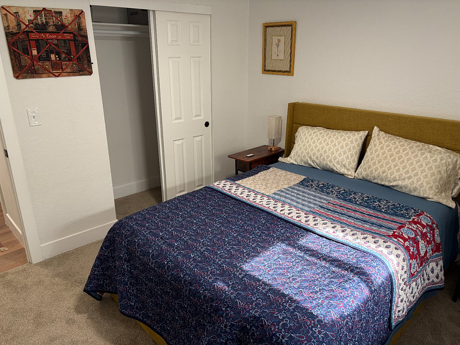 Spacious closet with additional bed linens and a hamper