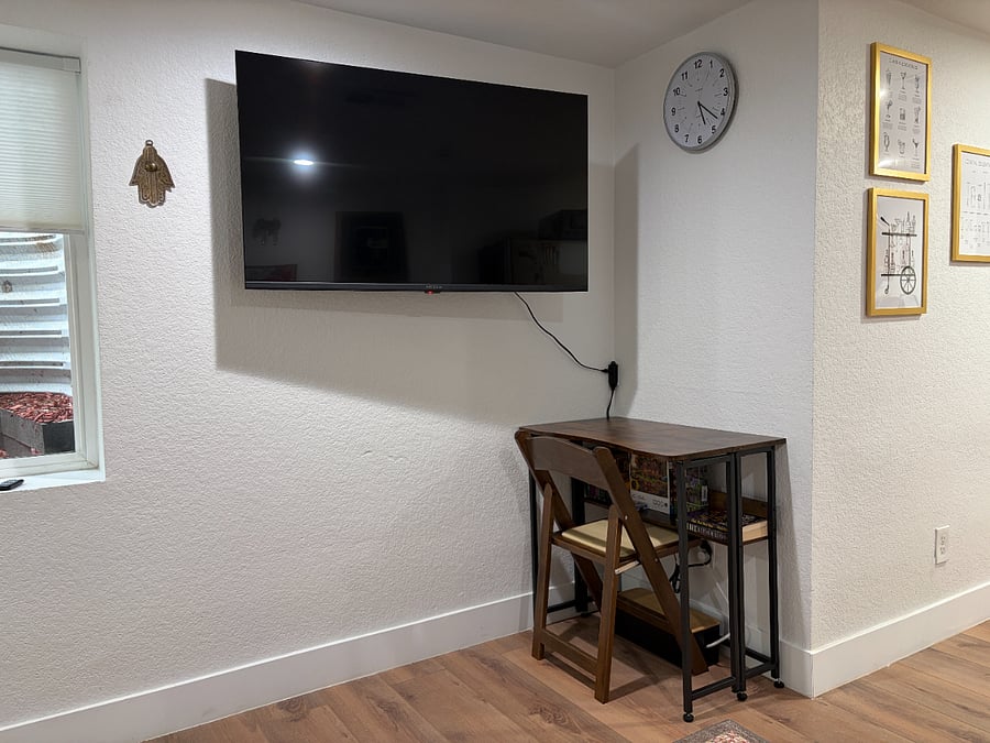 Quaint drop leaf table with a smart roku tv that can be shifted around for ease.