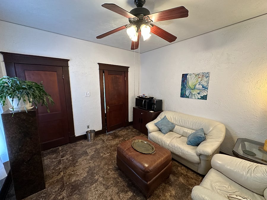 This second bedroom has been made into a workspace and TV viewing area with microwave and coffee maker.