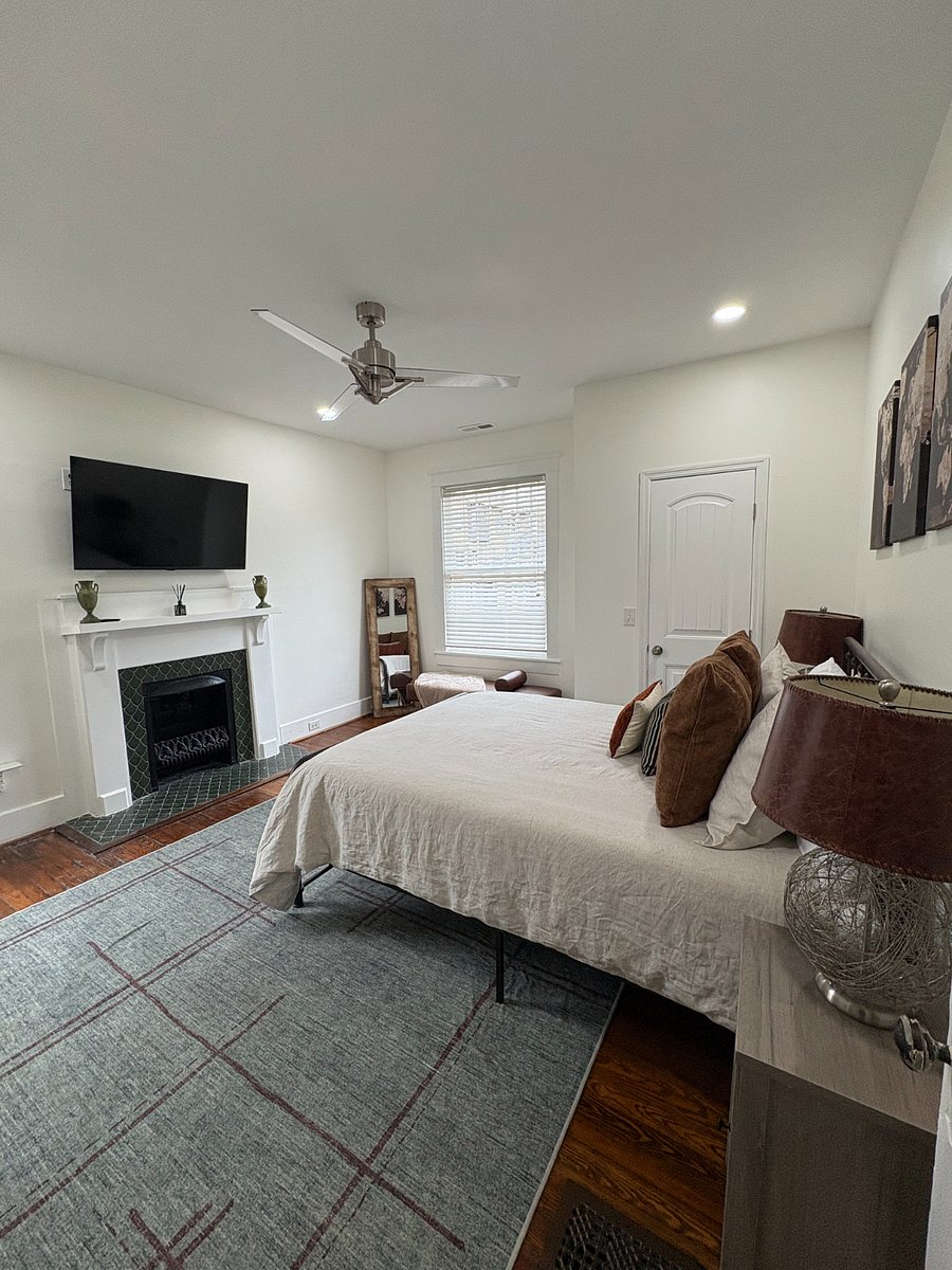Alternate view of Bedroom 2 highlighting the large smart TV for added comfort