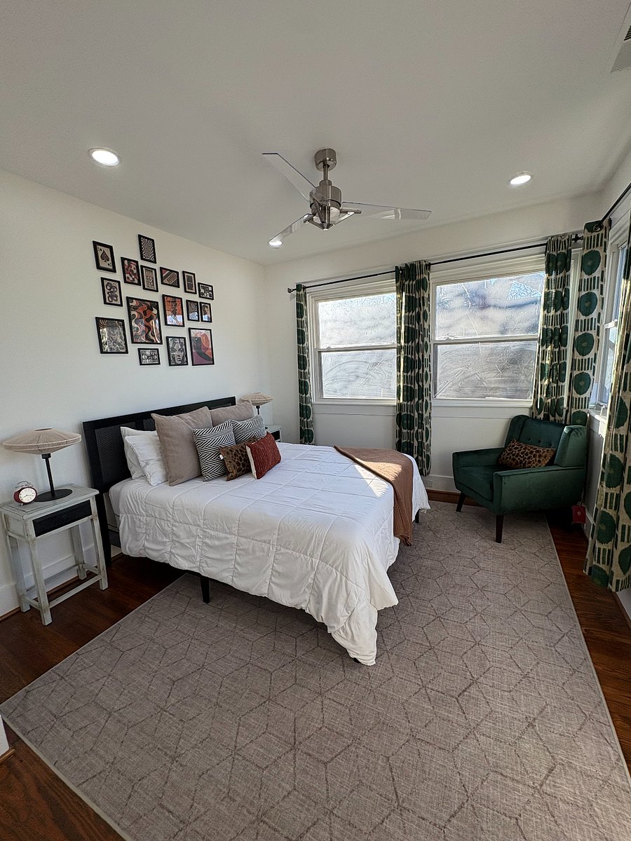 Bedroom 3 is the primary suite with an attached bathroom, large windows, and partial city skyline views