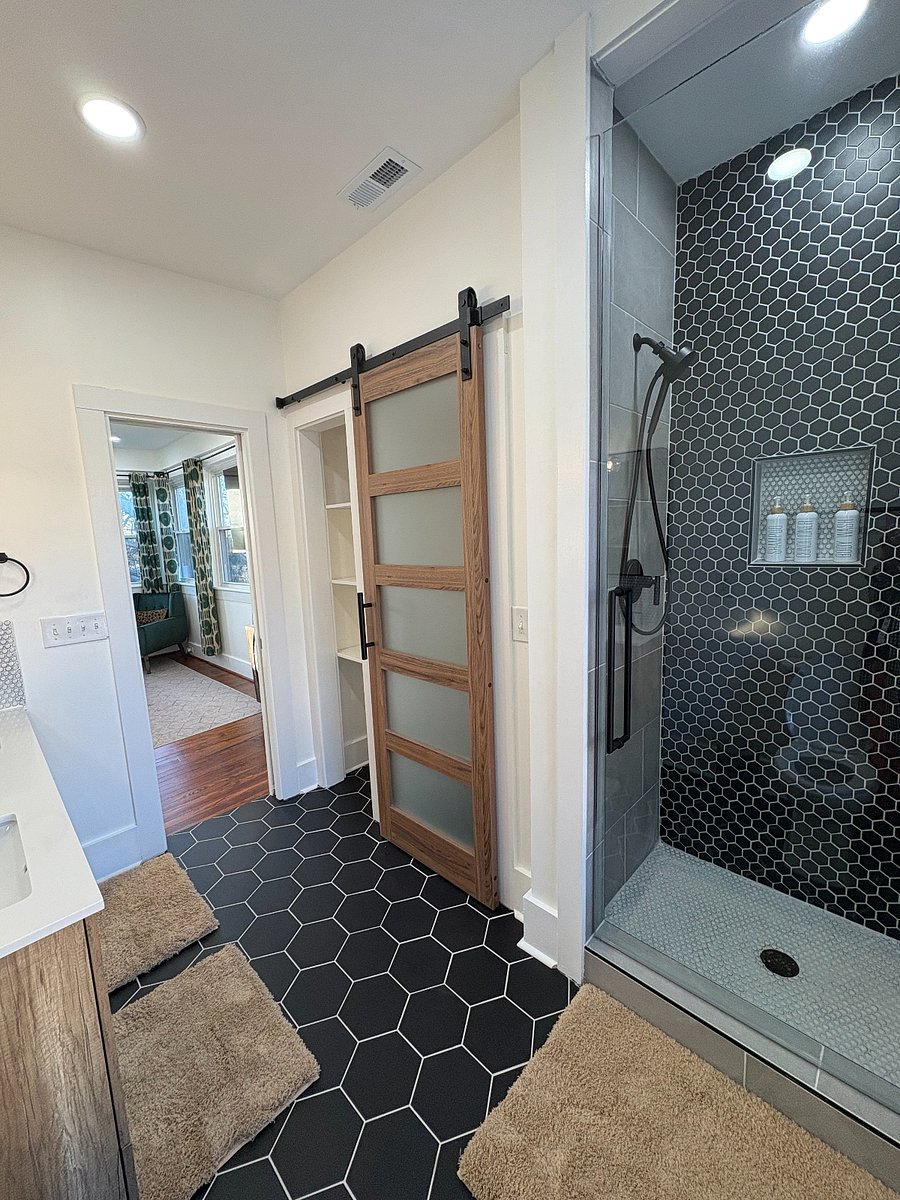 Primary bathroom includes an upgraded shower and a double vanity, providing added space and convenience