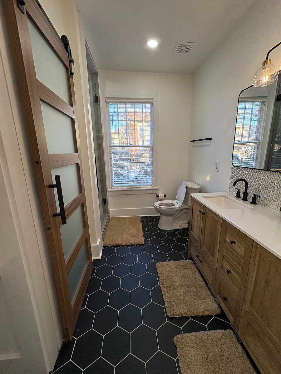 Alternate view of the primary bathroom highlighting the double vanity
