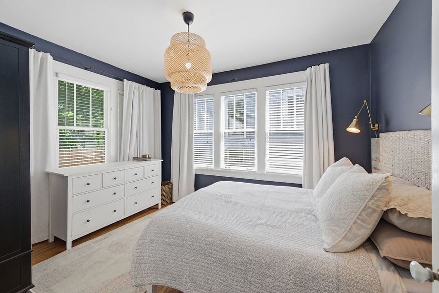 Main floor primary bedroom with Restoration Hardware armoire, dresser, and closet provide ample storage in the primary suite. Thoughtfully designed for comfort and function