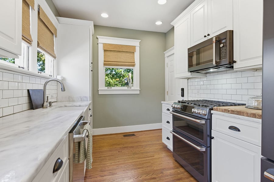 Kitchen overlooks the backyard with tons of windows and natural light. Your cooking space has a view