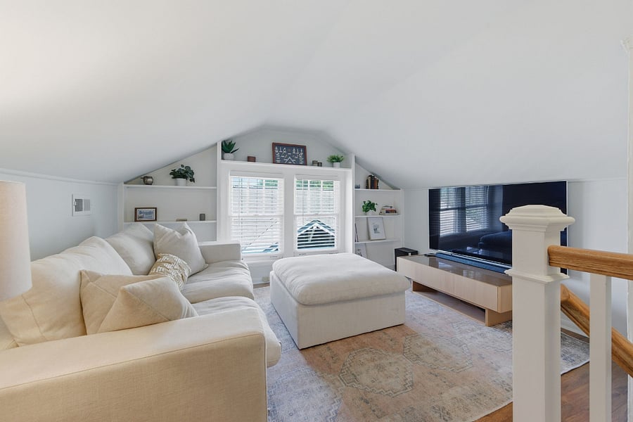 Upper floor flex space with TV and sofa. We think it's perfect for a second living area, office, or quiet retreat