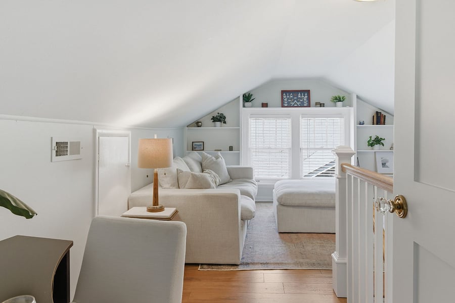 Cozy upper floor retreat with TV and sofa. Great for working, streaming, or a quiet getaway from the main living space