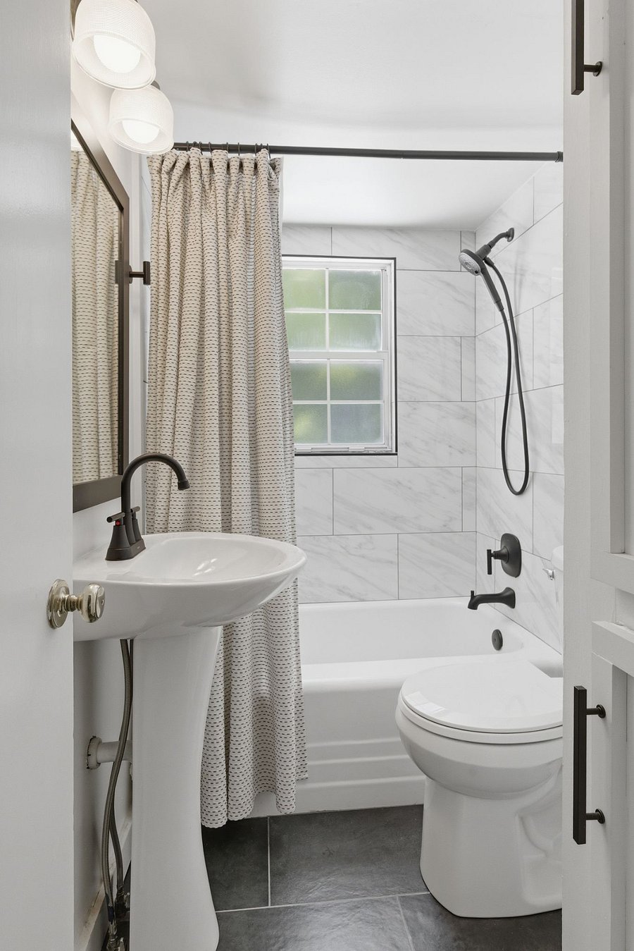 Upper floor bathroom. Compact in size, but large in style. We recently updated with quality finishes and a window overlooking the backyard. Linen cabinet keeps everything organized