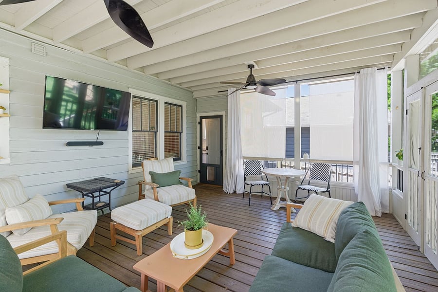 Multiple seating zones on the screened porch means everyone finds their spot. TV, Sonos, and backyard views from every seat.
