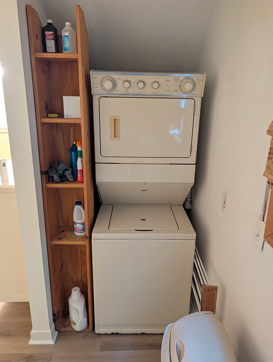 Stackable laundry unit adjacent to half bath