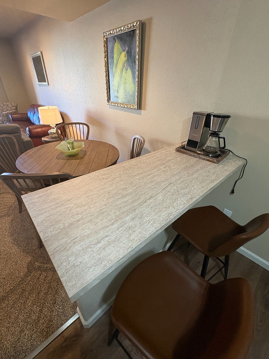 Additional counter with two chairs facing out to the main area from the kitchenette