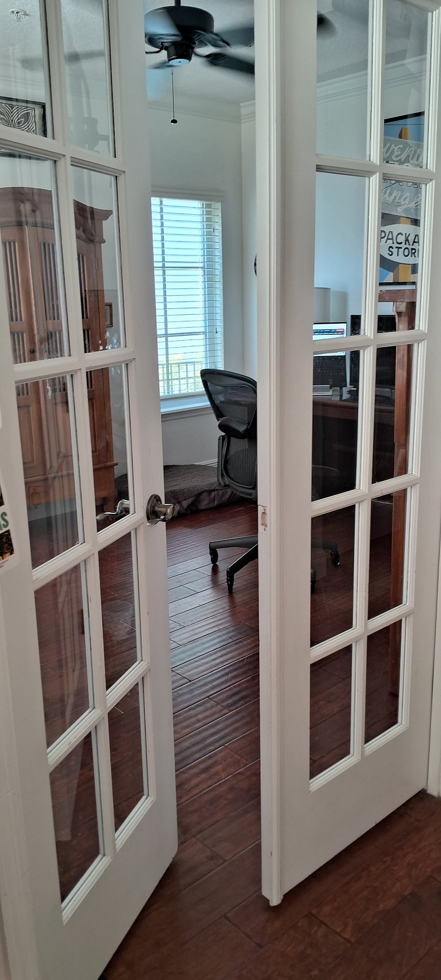 Enter through the French doors into the den/ office