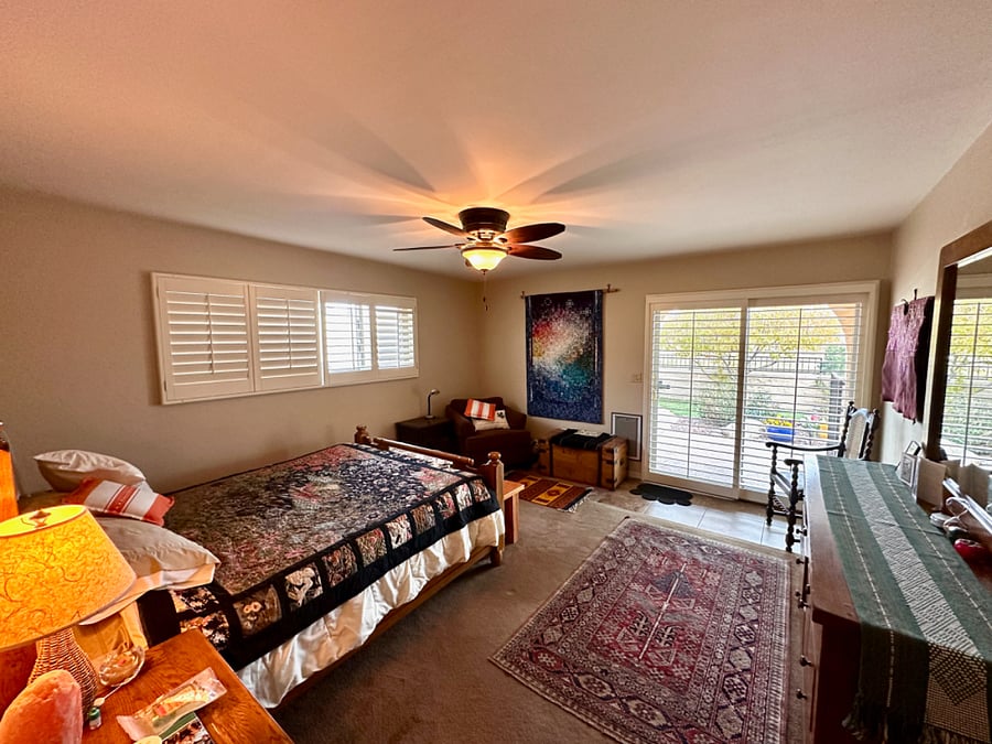 Primary bedroom has private sliding door access to patio