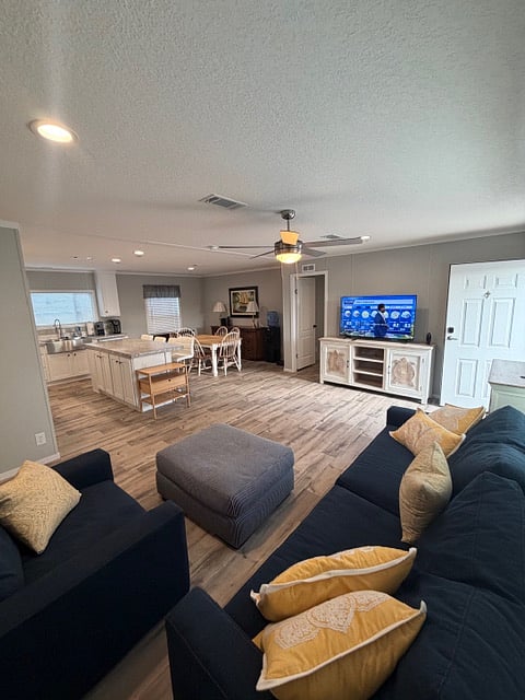 Large living room with comfy couches and 55" smart tv