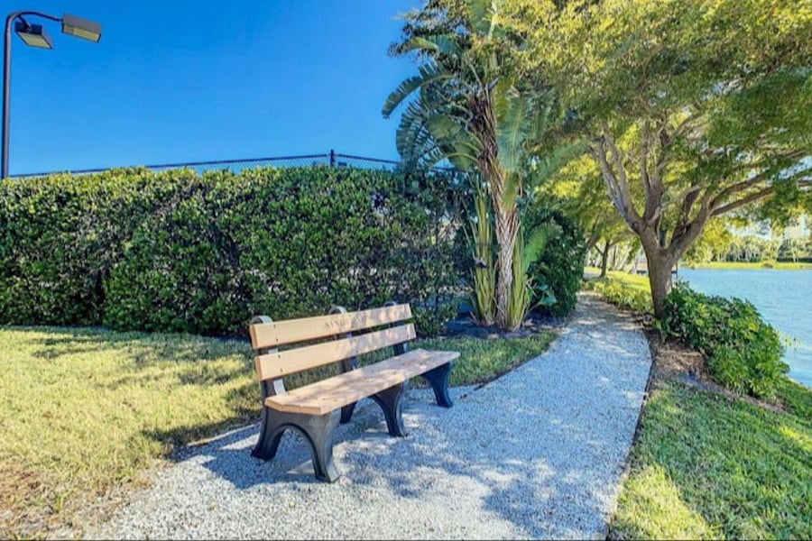 Walking path around the lake with benches