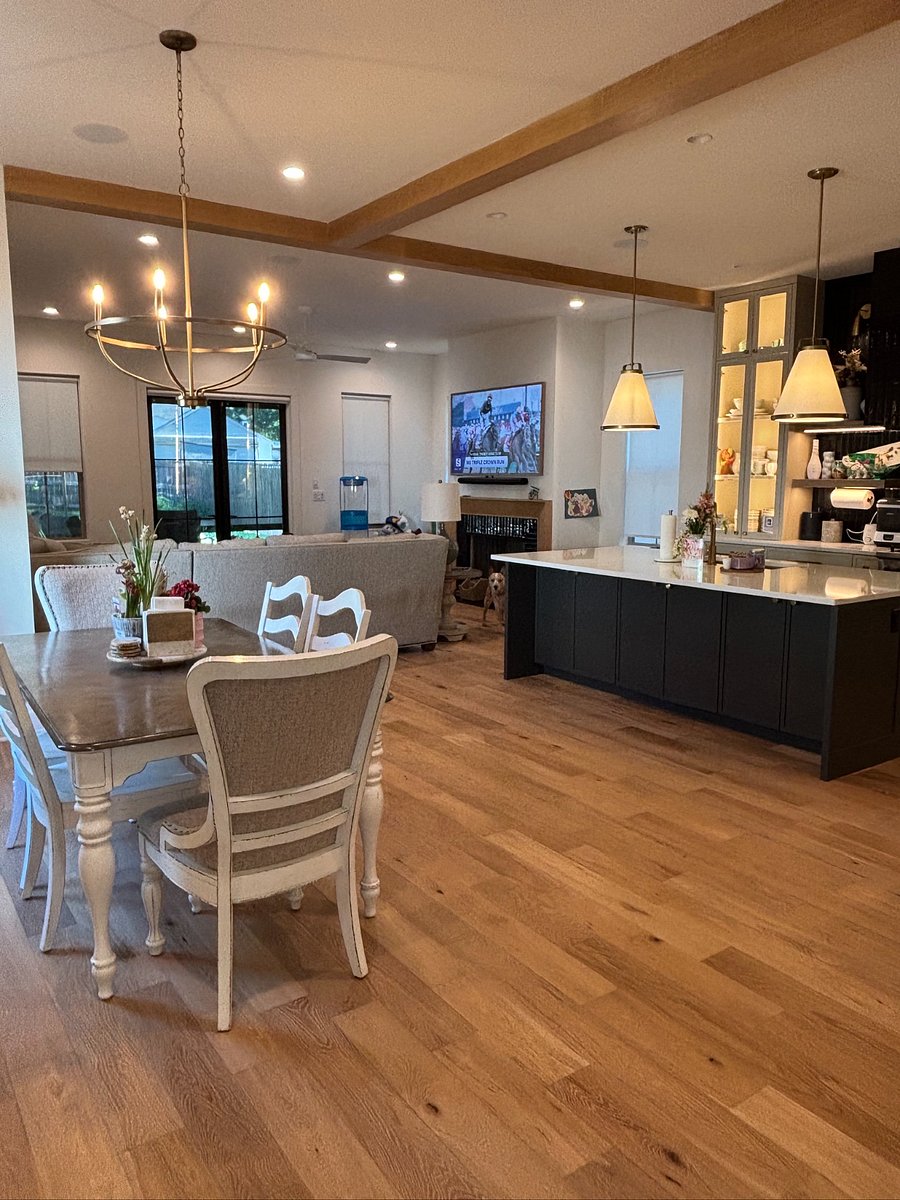 Spacious open-concept living with a seamless flow between the kitchen, dining, and den areas. Featuring custom finishes, oversized island seating, warm wood accents, and plenty of natural light  perfect for relaxing, entertaining, or enjoying time with family and friends.
