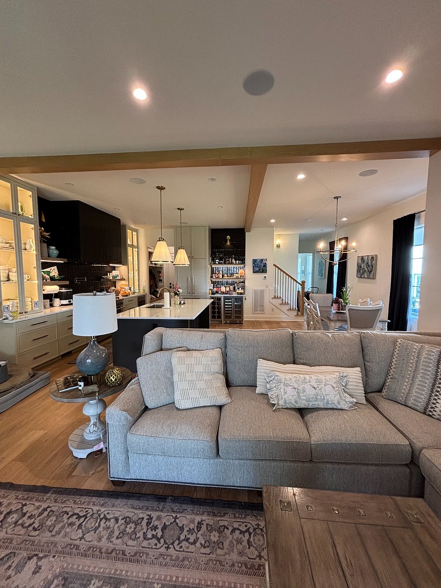 Bright and inviting open-concept living space featuring a spacious gourmet kitchen, oversized island, custom cabinetry, and seamless flow into the dining and living areas. Perfect for entertaining, relaxing with family, or enjoying a comfortable extended stay in Nashville.