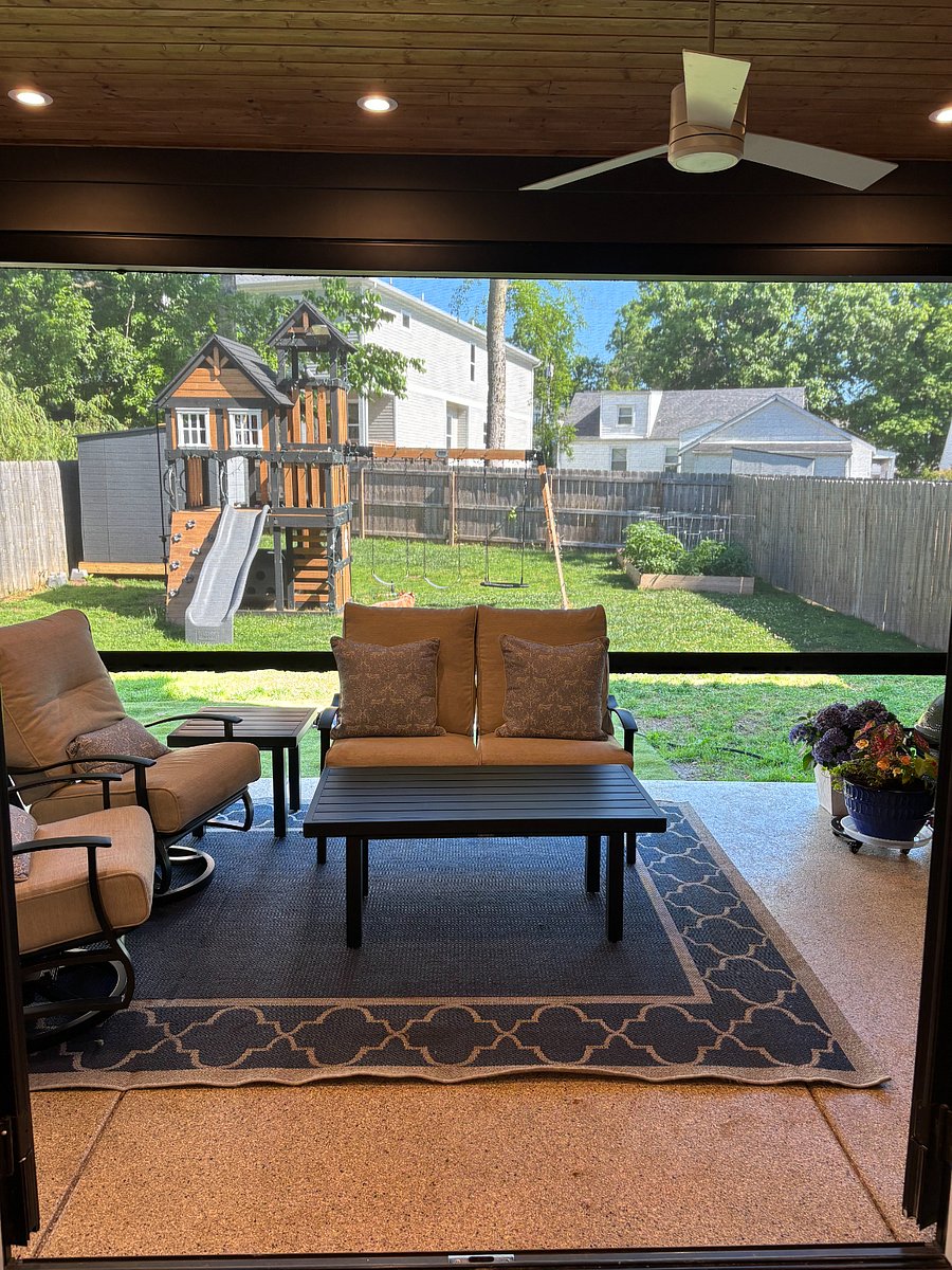 Relax and unwind on the screened-in patio featuring a retractable screen system for year-round enjoyment. Overlooking a spacious fenced backyard with a playset and swing set, this outdoor space is perfect for families, entertaining, or enjoying a quiet Nashville evening.