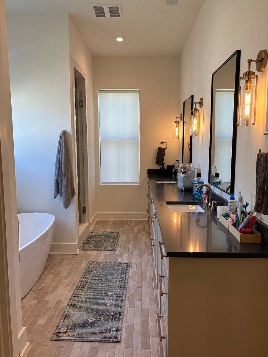 Spa-like master bathroom featuring dual vanities, modern finishes, a walk-in shower, and a relaxing soaking tub. Designed with comfort and space in mind, this private retreat offers the perfect place to unwind after a long day.