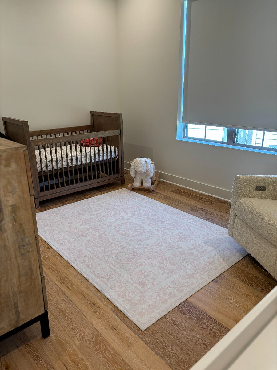 Flexible bedroom space currently set up as a nursery, offering a peaceful and comfortable area for families with young children. A full queen bedroom suite can also be provided if preferred, allowing the room to easily accommodate additional adult guests.