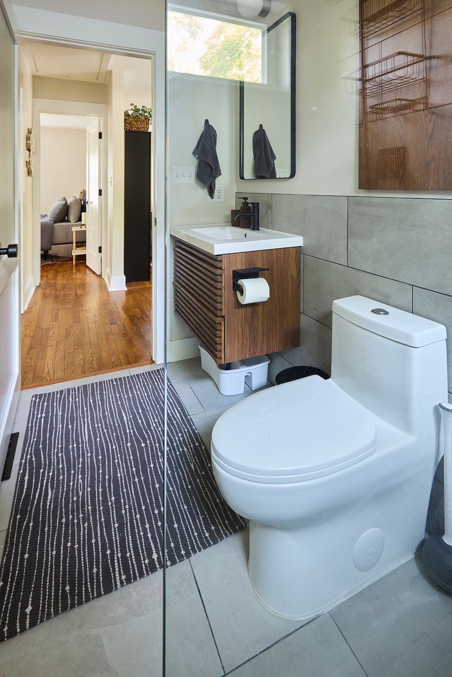 Bathroom - Frameless glass wall, zero entry shower floor, designer black fixtures, basic toiletries