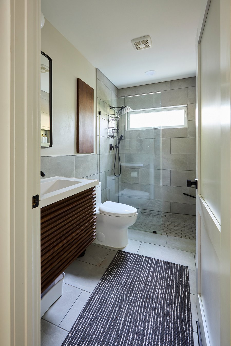 Bathroom - Frameless glass wall, zero entry shower floor, designer black fixtures, rainfall showerhead and handheld wand combo