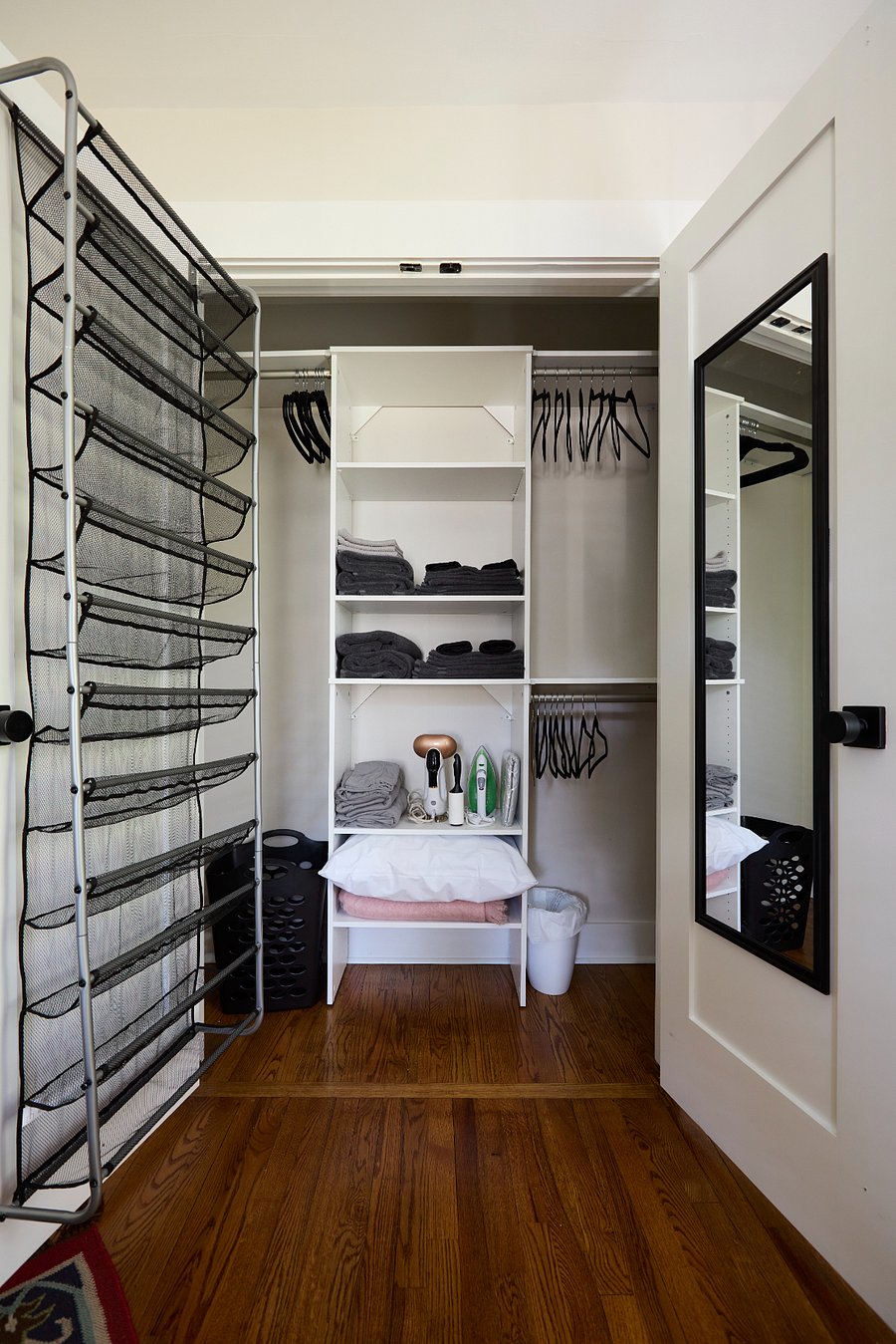 Primary Closet Storage - Hotel-inspired comforts: hangers, iron, ironing board, steamer, extra bedding, towels and makeup washcloths