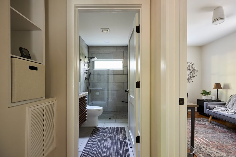 Hallway view - Storage alcove and shelves offer additional area for personal effects, towels, linens.
