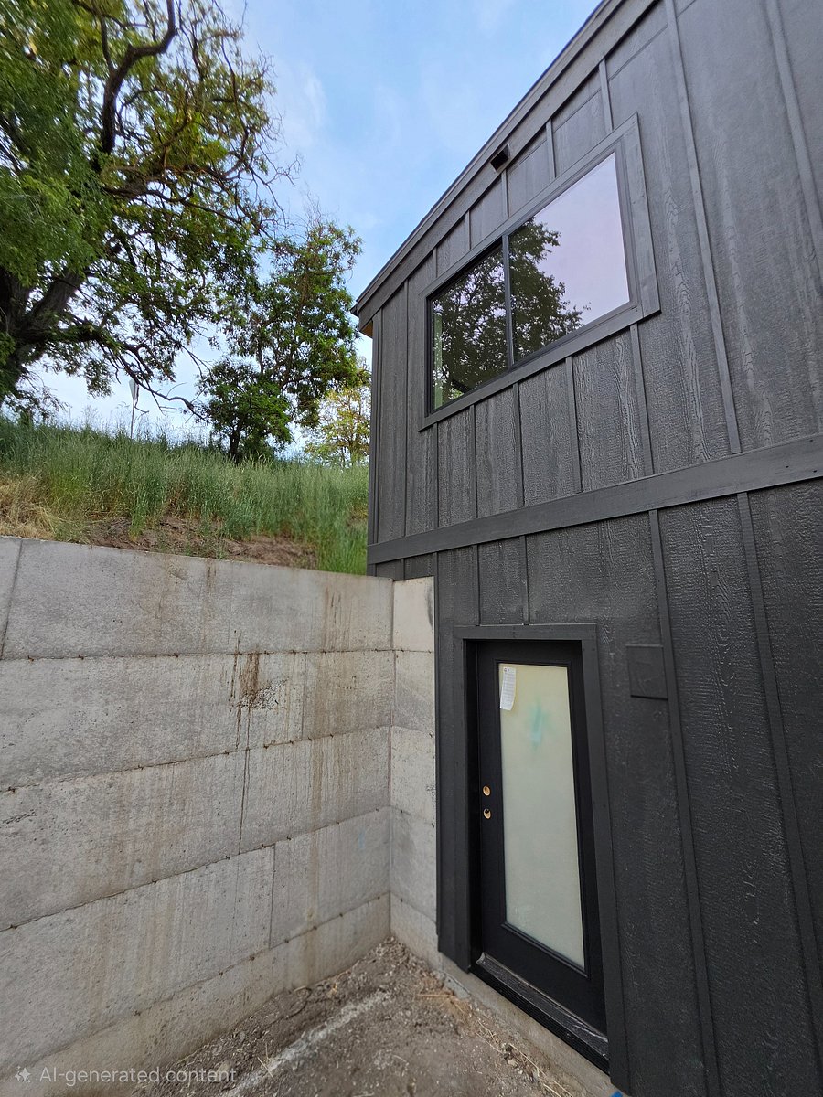Main entry door into mudroom with bench and coatrack.