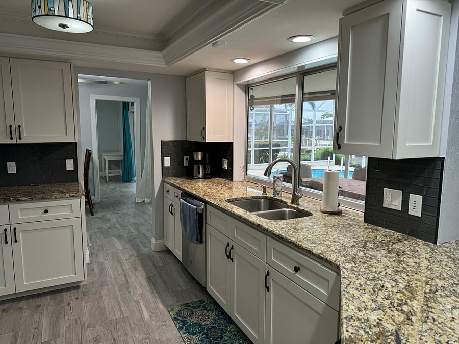 Very well stocked kitchen with view out toward lanai
